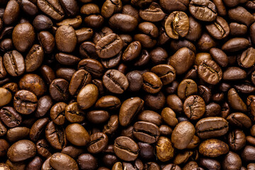 Fresh roasted coffee bean background. Background of roasted coffee beans, top view