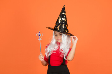 happy witch girl with magic wand wear costume of wizard on halloween party, halloween enchantment
