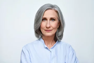 Foto op Canvas Confident beautiful mature business woman standing isolated on white background. Older senior businesswoman, 60s grey haired lady professional looking at camera, close up face headshot portrait. © insta_photos