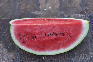Fototapeta na wymiar fresh sliced ​​watermelon on brick background.