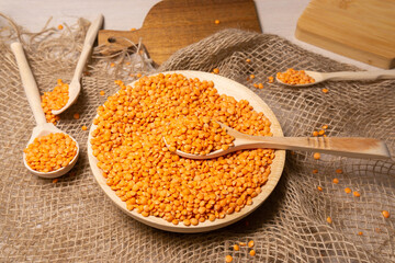 orange lentils in a wooden bowl. selective focus