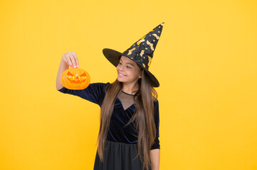 halloween child in witch hat hold pumpkin jack o lantern for witchcraft, happy halloween