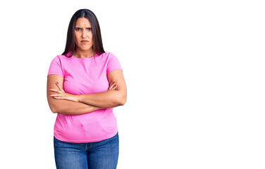 Young beautiful brunette woman wearing casual t-shirt skeptic and nervous, disapproving expression on face with crossed arms. negative person.