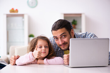 Young man and his small daughter preparing for the trip