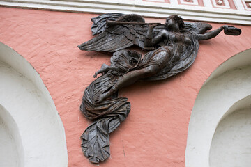 Metal angels blowing trumpets on the wall of the Donskoy Monastery