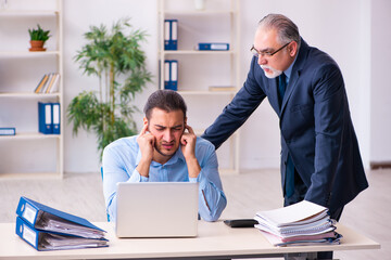 Old boss and his young assistant in the office