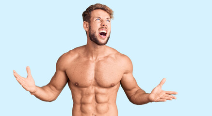 Young caucasian man standing shirtless crazy and mad shouting and yelling with aggressive expression and arms raised. frustration concept.