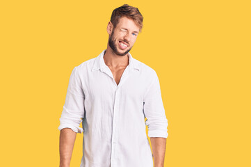Young caucasian man wearing casual clothes winking looking at the camera with sexy expression,...