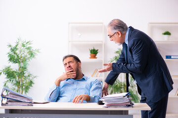 Old boss and his young assistant in the office
