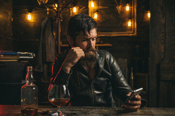 Hipster sad man using mobile cell phone. Concept of sadness social addicted. Man quarrel, break up with smartphones.