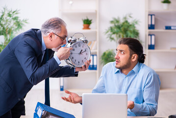 Old boss and his young assistant in the office