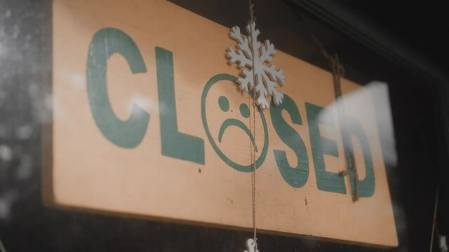 ign hanging on the door with the inscription closed with sad smile