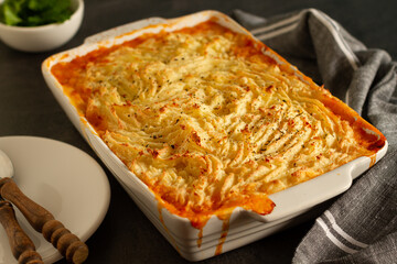 Shepherd's pie, traditional British dish with minced meat and mashed potato on rustic wooden table