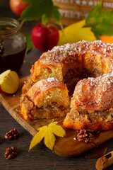 Homemade, rustic apple bundt cake on autumn decoration table