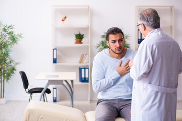 Young sick man visiting old doctor