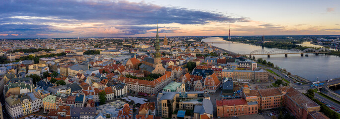 Magical stormy sunset over Riga old town - the capital of Latvia. Stormu clouds forming in the sky. Beautiful Riga at sunset. © Aerial Film Studio