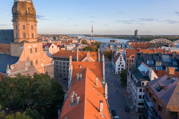 Sunrise over central Riga, Latvia. Aerial view of the St. Peter's Church. Close up panoramic view...