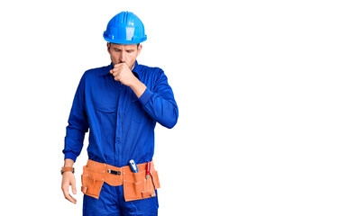Young handsome man wearing worker uniform and hardhat with hand on stomach because indigestion, painful illness feeling unwell. ache concept.