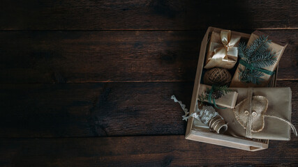 Sustainable Christmas, zero waste gifts, natural xmas decorations. Wrapping Christmas gifts in recycled brown paper in wooden care box. Vintage style Christmas packaging ideas