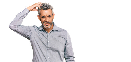 Fototapeta premium Middle age grey-haired man wearing casual clothes confuse and wonder about question. uncertain with doubt, thinking with hand on head. pensive concept.