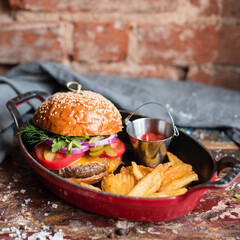 Cheeseburger with Tomato, Pickles and Onion Served with Potato Fries and Tomato Ketchup