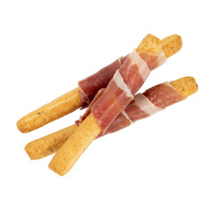 Bread sticks grissini with italian prosciutto crudo or spanish jamon.