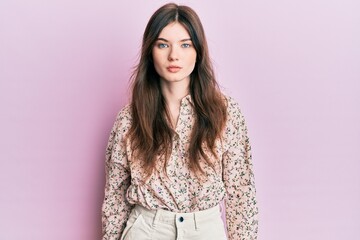 Fototapeta premium Young beautiful caucasian girl wearing elegant clothes with serious expression on face. simple and natural looking at the camera.