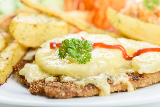 cutlet with pineapple and  baked potatoes with bouquet of salads