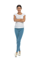 Positive casual woman smiling with hands and legs crossed