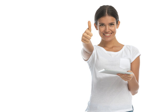 Positive casual woman gesturing ok and holding tablet