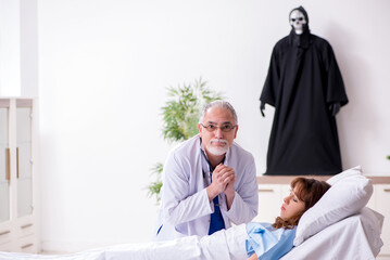 Devil, old doctor and female patient in the clinic