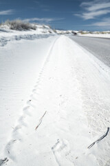 white sand covered road