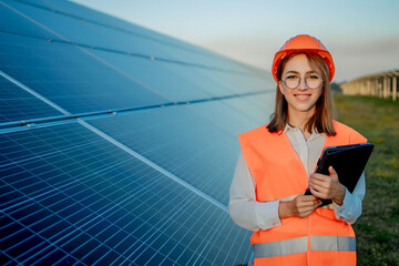 Inspector Engineer Woman Holding Digital Tablet Working in Solar Panels Power Farm, Photovoltaic Cell Park, Green Energy Concept