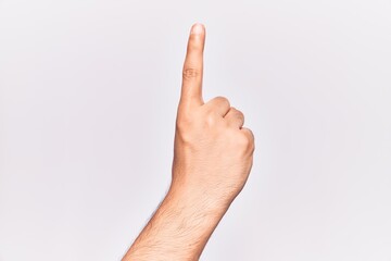 Close up of hand of young caucasian man over isolated background counting number one using index finger, showing idea and understanding