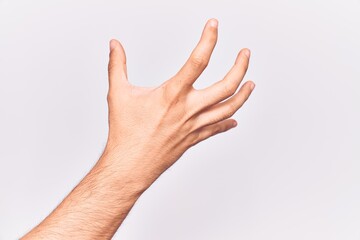 Close up of hand of young caucasian man over isolated background grasping aggressive and scary with fingers, violence and frustration