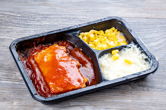 Rib TV dinner served in its plastic tray and cooked