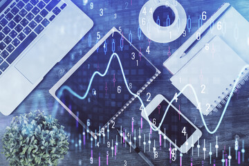 Double exposure of forex chart hologram over desktop with phone. Top view. Mobile trade platform concept.