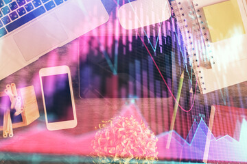 Double exposure of forex chart hologram over desktop with phone. Top view. Mobile trade platform concept.