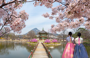 Gyeongbokgung Palace  Hyangwonjeong Pavilion, with Korean national dress and.cherry blossom in...