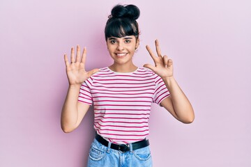 Young hispanic girl wearing casual clothes showing and pointing up with fingers number eight while smiling confident and happy.
