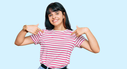 Young hispanic girl wearing casual clothes looking confident with smile on face, pointing oneself...