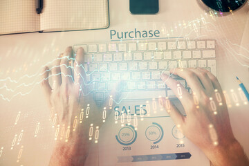 Double exposure of man's hands typing over laptop keyboard and forex chart hologram drawing. Top view. Financial markets concept.