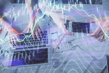 Multi exposure of man and woman working together and forex graph hologram drawing. Financial analysis concept. Computer background. Top View.