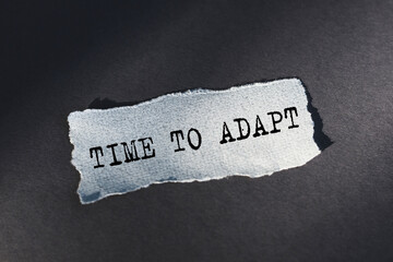 Time To Adapt Text written in torn paper