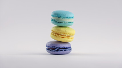 Three French macaroons. Stack of purple, yellow and turquoise macaron sweets