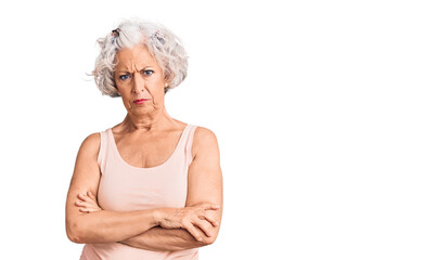 Senior grey-haired woman wearing casual clothes skeptic and nervous, disapproving expression on face with crossed arms. negative person.