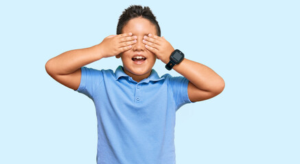 Fototapeta premium Little boy hispanic kid wearing casual clothes covering eyes with hands smiling cheerful and funny. blind concept.