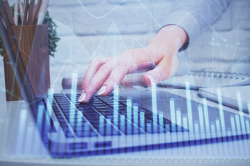 Fototapeta na wymiar Multi exposure of woman hands typing on computer and forex chart hologram drawing. Stock market analysis concept.