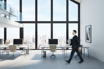 Businessman walking in coworking two-story loft office interior