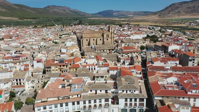 Aerial view of fortified castle and Basilica of Vera Cruz on hill dominating residential areas of Spanish town of Caravaca de la Cruz on summer day. High quality 4k footage